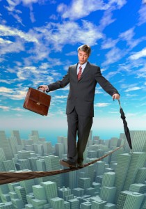 Businessman balancing on rope over a big city