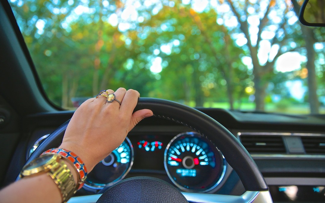 control driving image of left hand holding the steering wheel